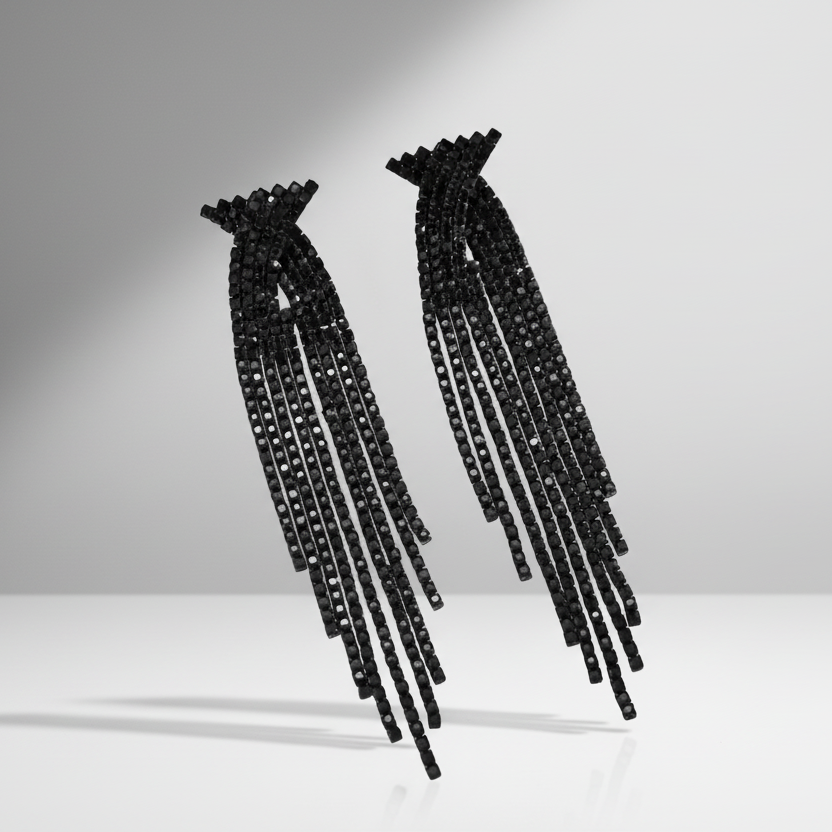 Pair of black beaded earrings on a light gray background