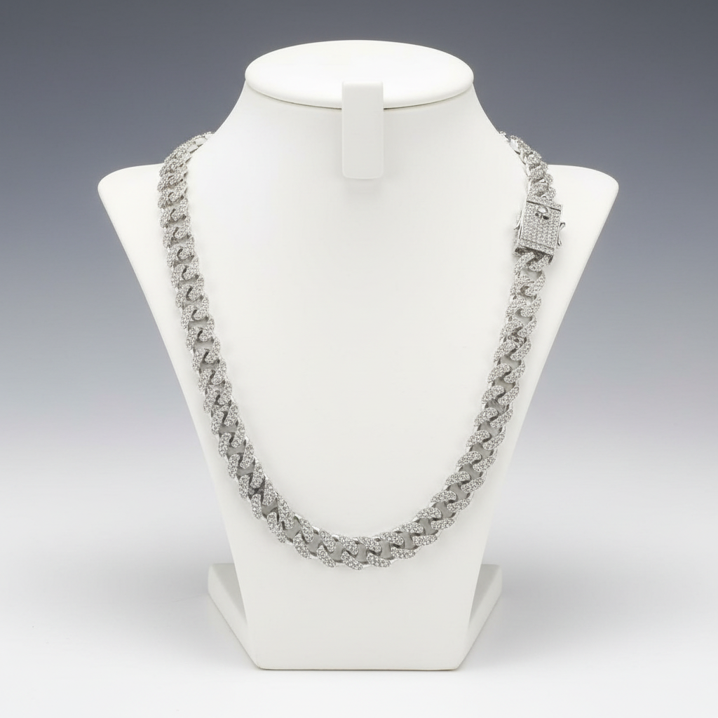 Silver necklace on a white mannequin bust against a gray background