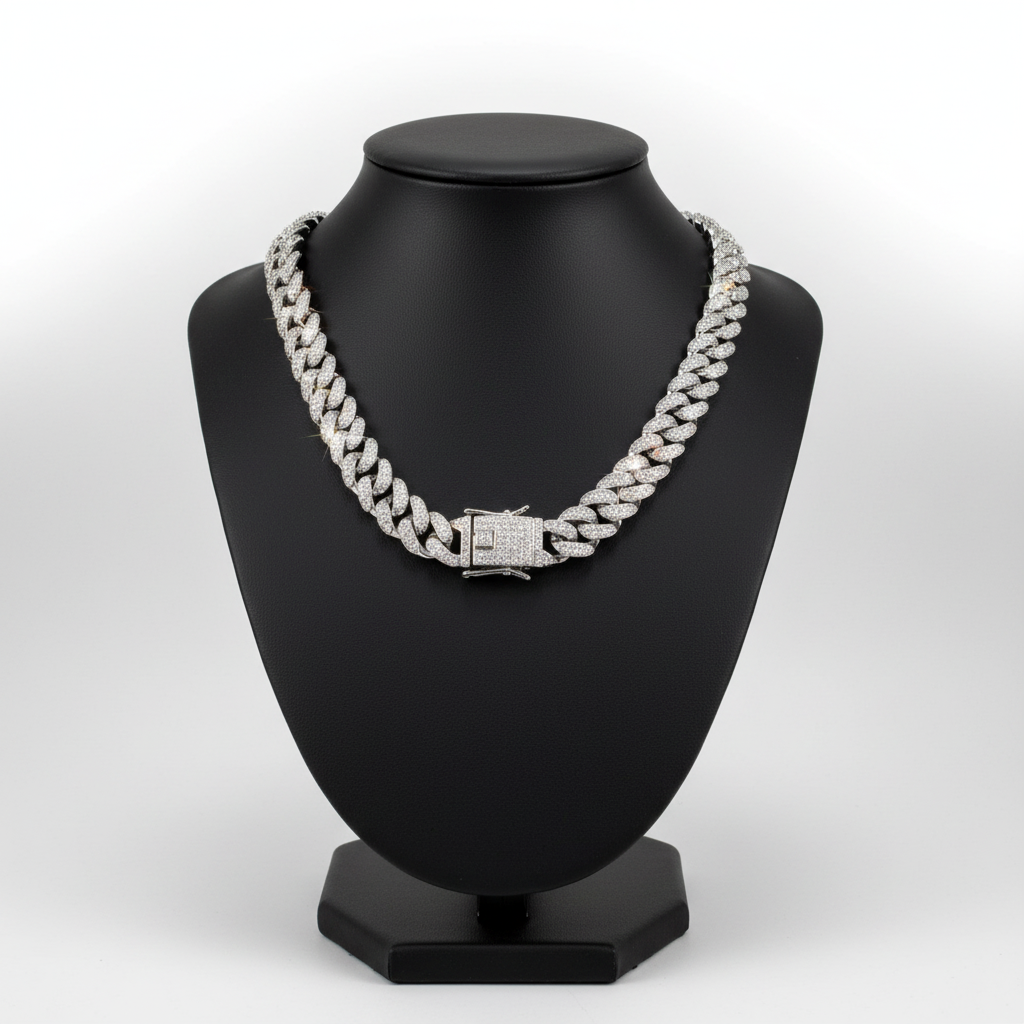 Silver chain necklace on a black mannequin bust against a white background