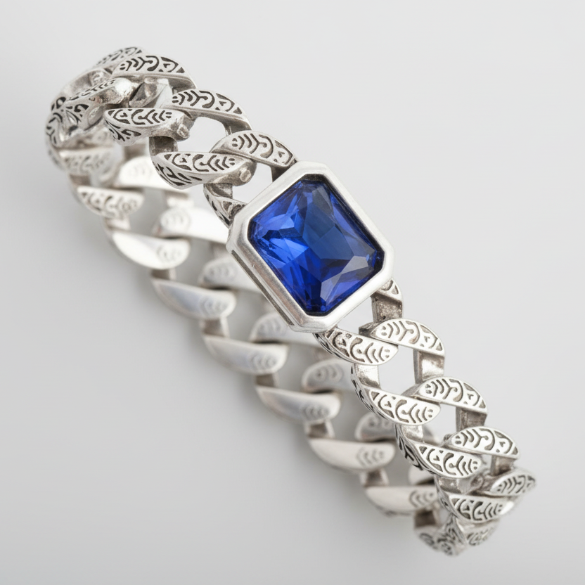 Silver bracelet with a blue gemstone on a light gray background