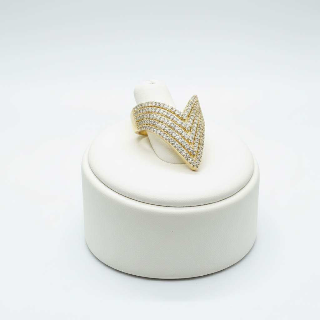 Gold ring with a white stone on a gray surface