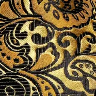 Close-up of a gold and black paisley pattern fabric
