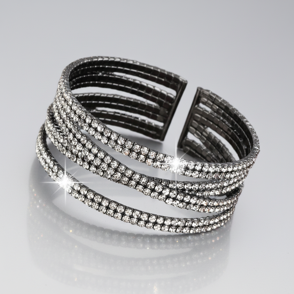 Black bracelet with crystal embellishments on a reflective surface