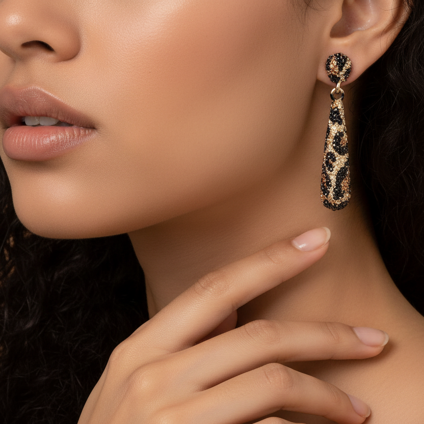 Close-up of a woman wearing a leopard print earring with a neutral background