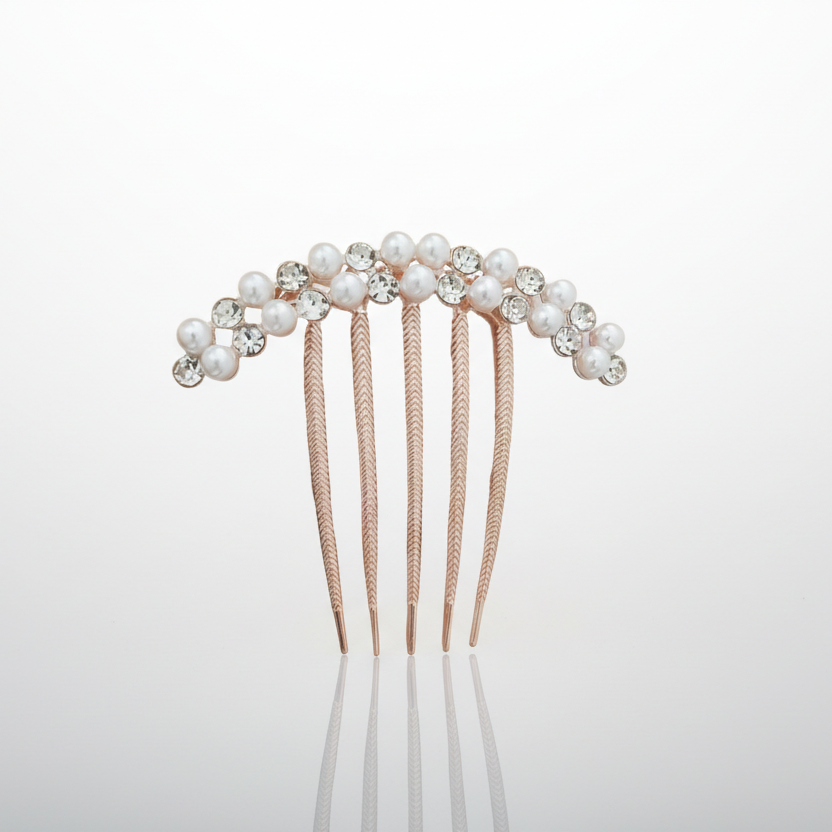 Hair comb with pearls and crystals on a light gray background