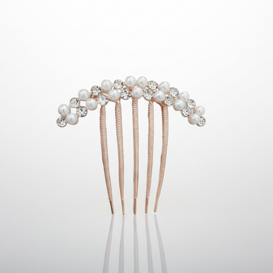 Hair comb with pearls and crystals on a light gray background