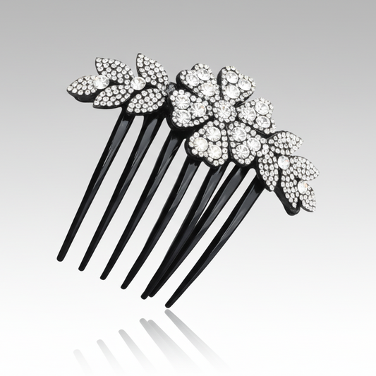 Black hair comb with decorative flowers and crystals on a gray background