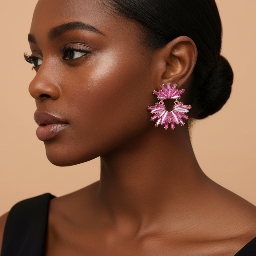 Woman wearing pink floral earrings against a beige background