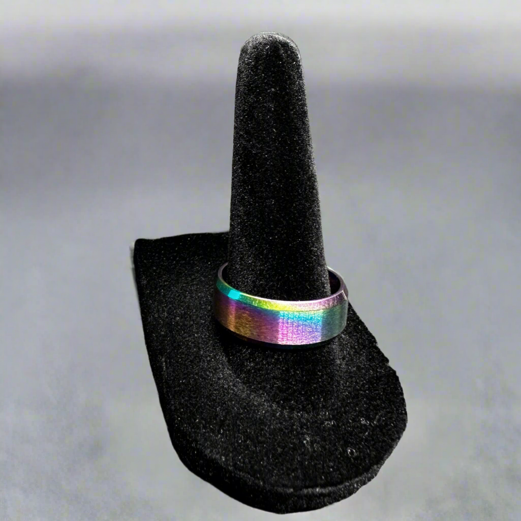 Multicolored ring on a black ring stand against a gray background