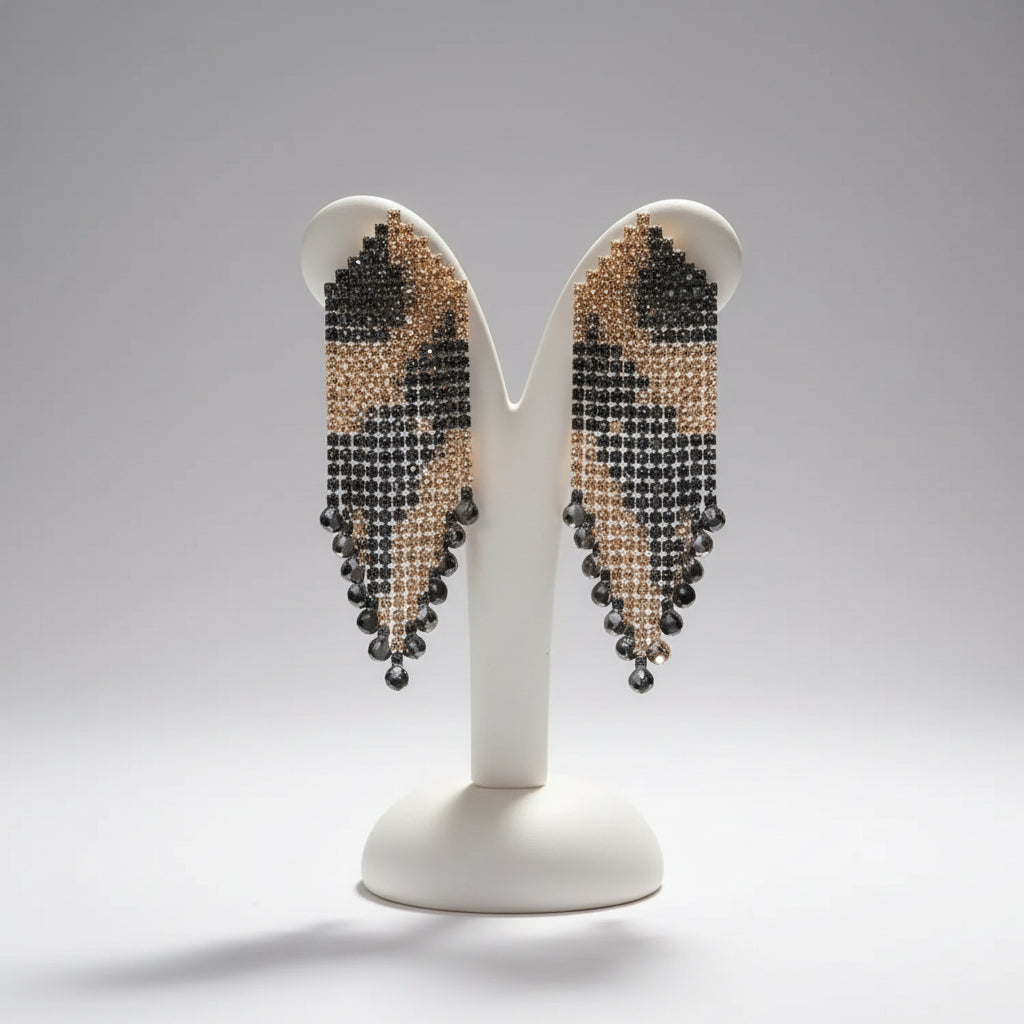 Close-up of a person wearing sparkling earrings with a blurred background