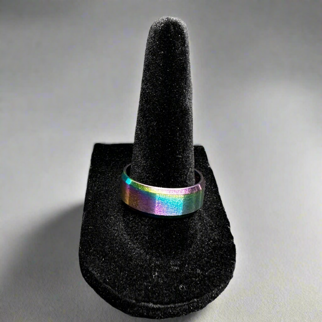 Multicolored ring on a black ring stand against a gray background