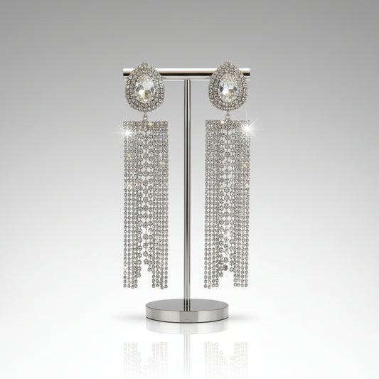 Pair of long, dangling earrings with crystal-like stones on a white background