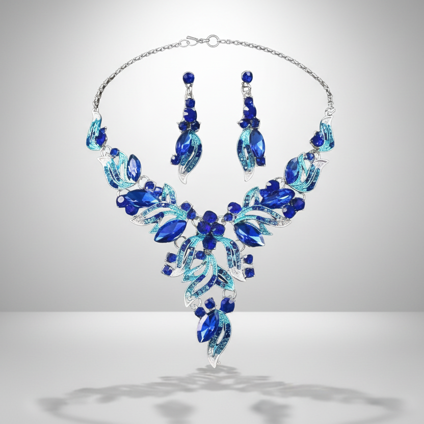 A silver-tone jewelry set with blue leaf-shaped charms and blue drop-shaped earrings.