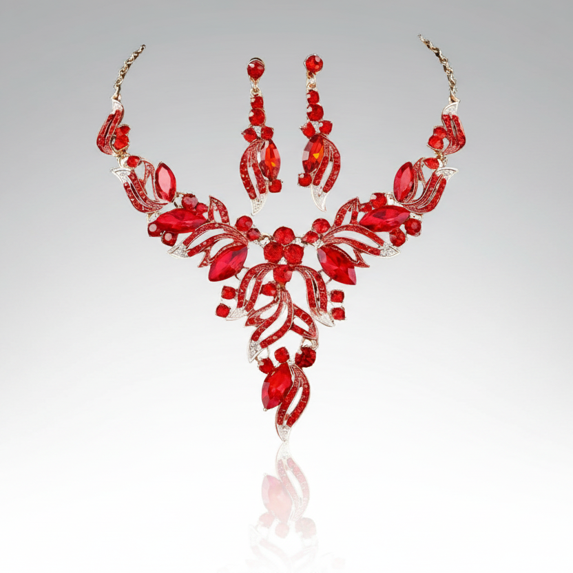 Red jewelry set with necklace and earrings on a gray background