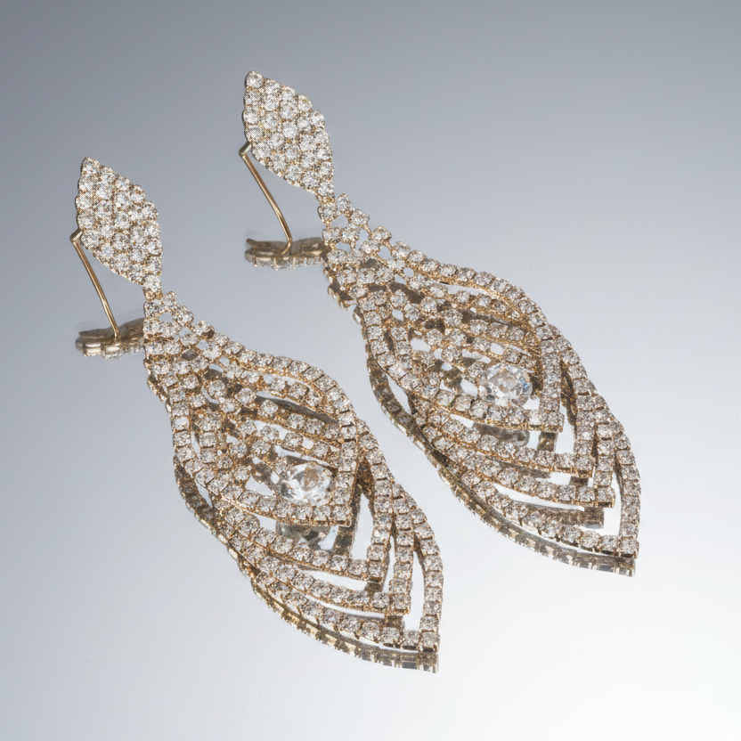 Pair of diamond earrings on a gray background