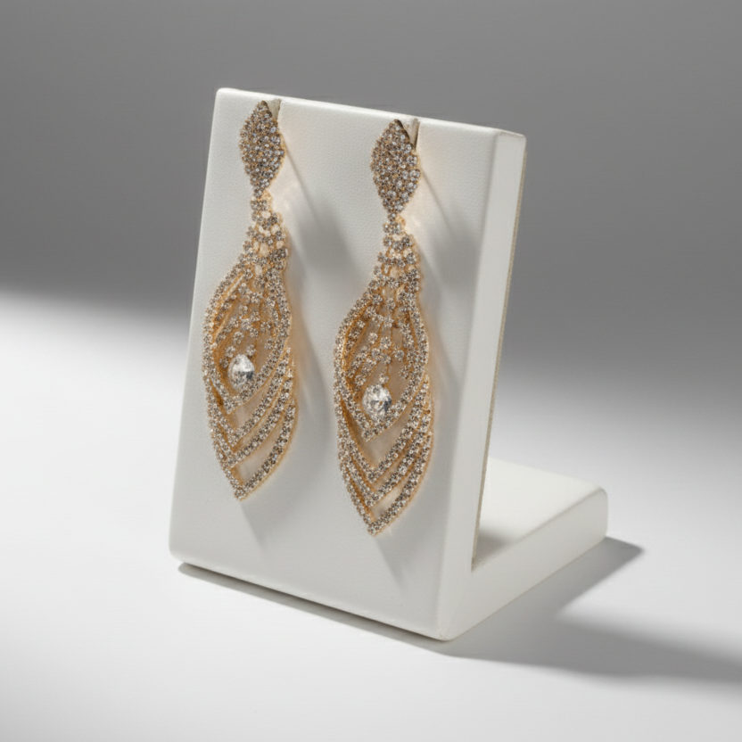 Pair of gold earrings on a light gray background
