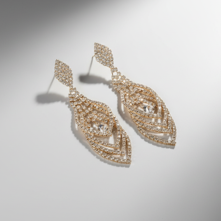 Pair of gold earrings on a light gray background