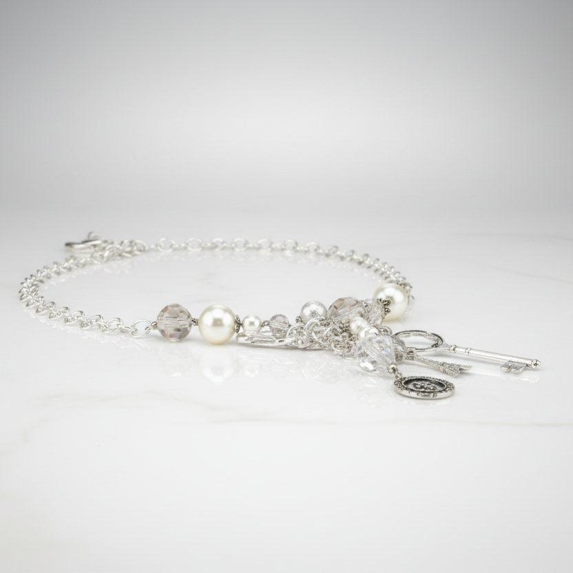 Silver bracelet with pearls and crystals on a light gray background