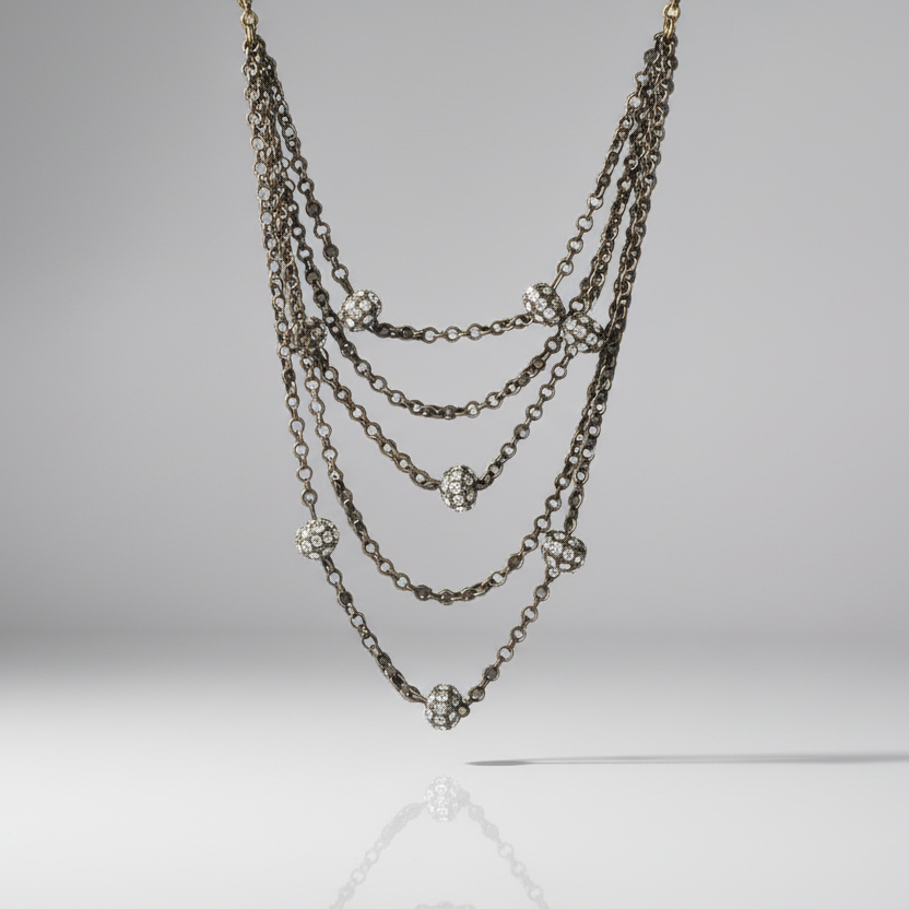Multi-layered chain necklace with floral pendants on a gray background