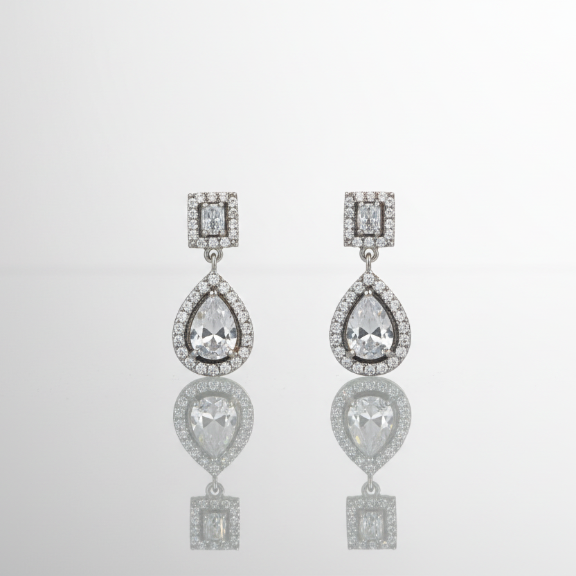 Pair of diamond earrings on a light gray background