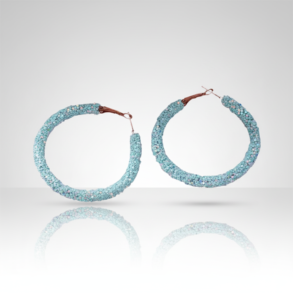 A pair of green sequin hoop earrings with delicately attached sequins.