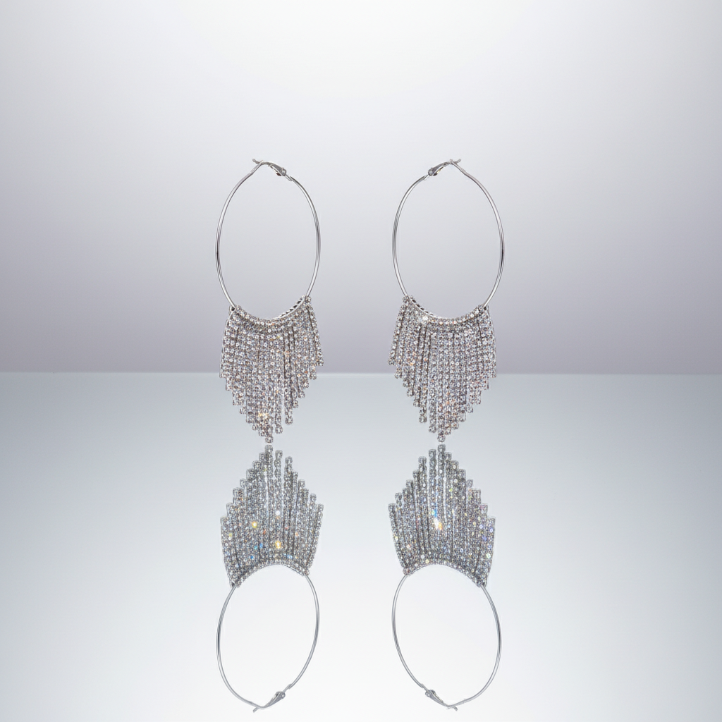 Pair of silver hoop earrings with beaded fringe on a light gray background