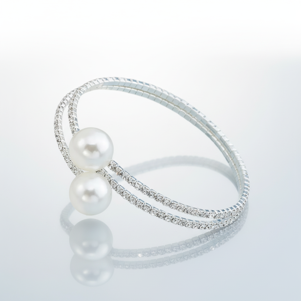 Silver bracelet with pearls on a light gray background