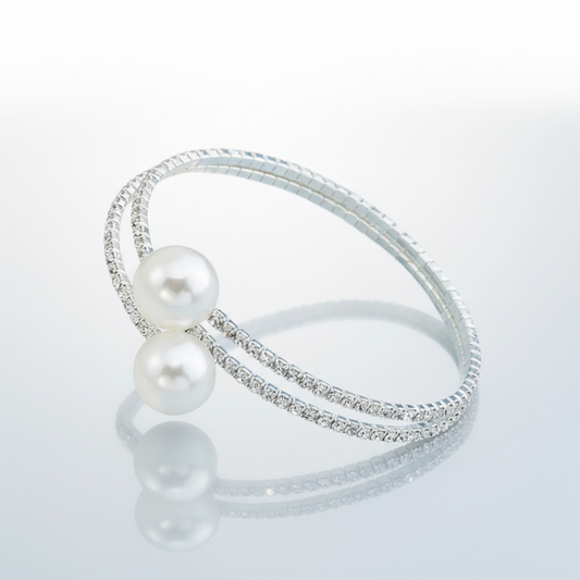 Silver bracelet with pearls on a light gray background