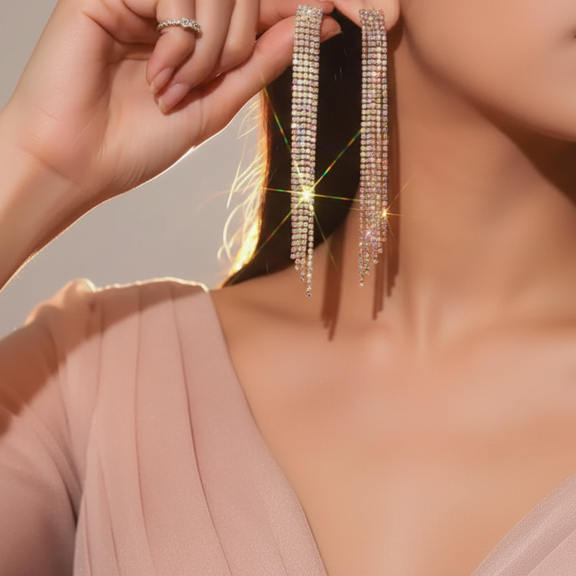 Close-up of a woman wearing sparkling earrings with a neutral background