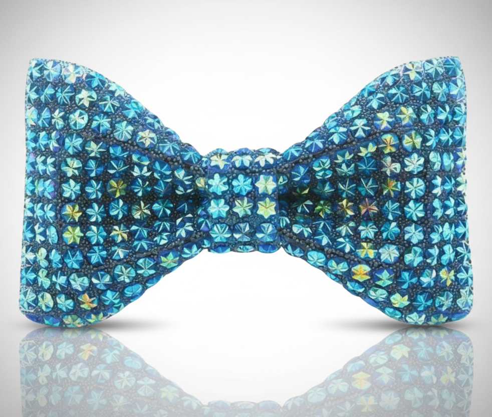 Blue floral patterned bow tie on a reflective surface with a light gray background