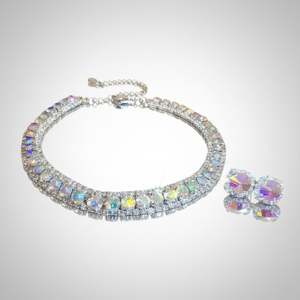 Jewelry set with a necklace and earrings featuring multicolored gemstones on a light gray background.