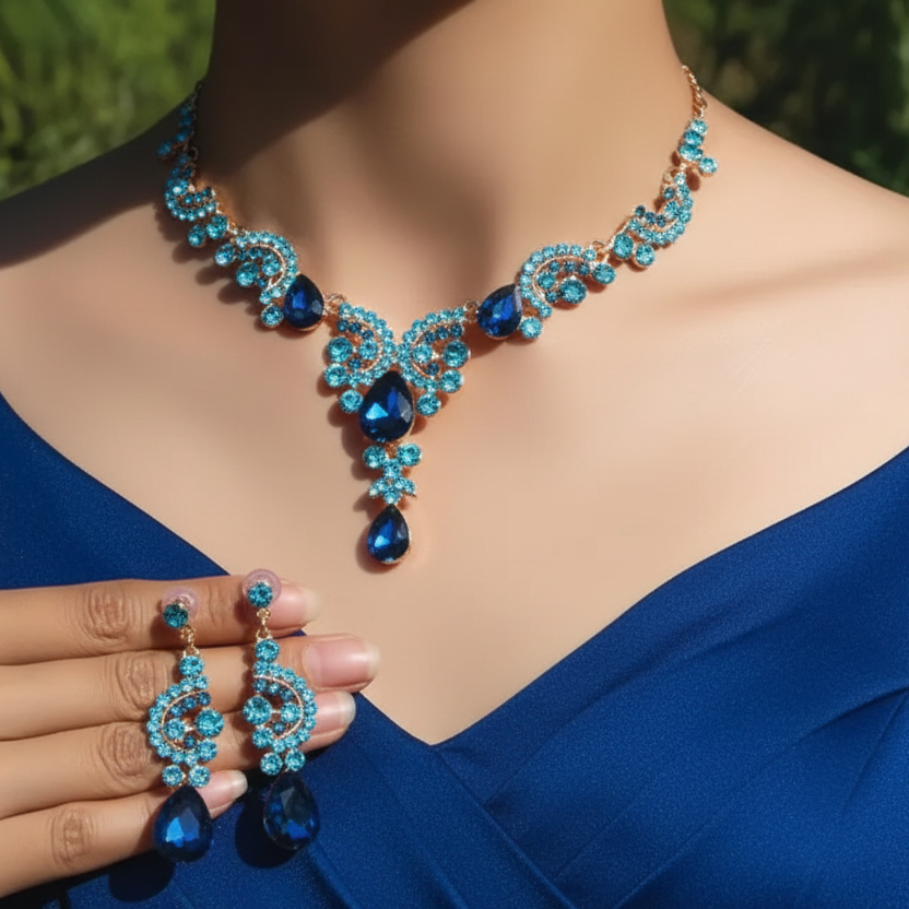 Blue jewelry set with necklace and earrings on a model wearing a blue dress.