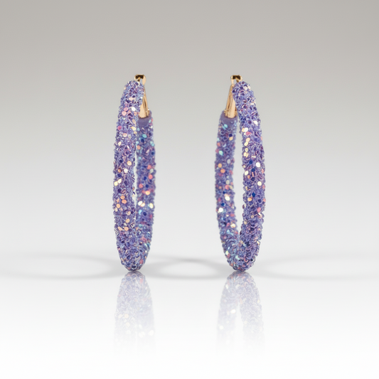 A pair of purple, blue, and gold sequin hoop earrings.