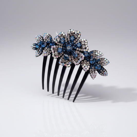 A dark blue rhinestone flower hair comb with multiple petals and a sparkle effect.
