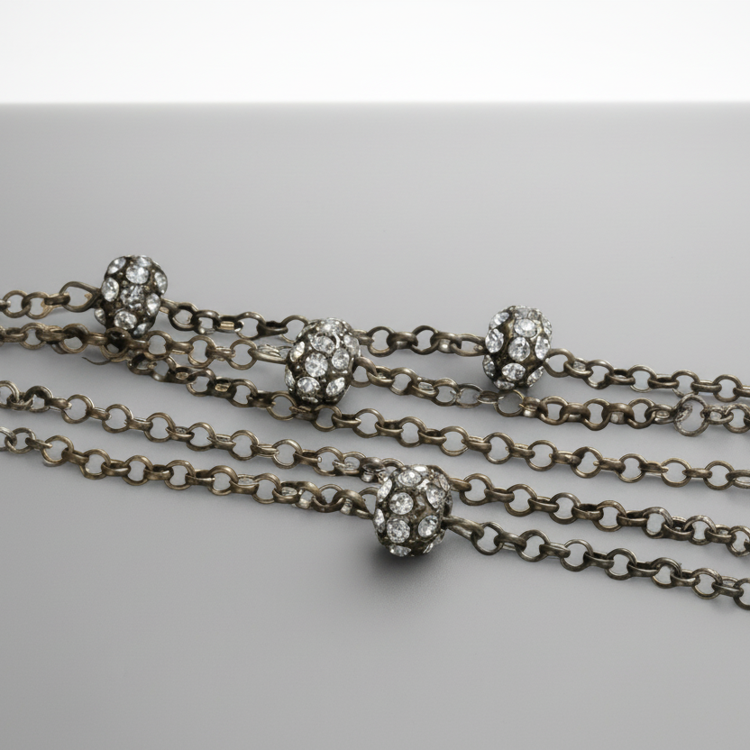 Silver chain necklace with decorative clasp on a light gray background