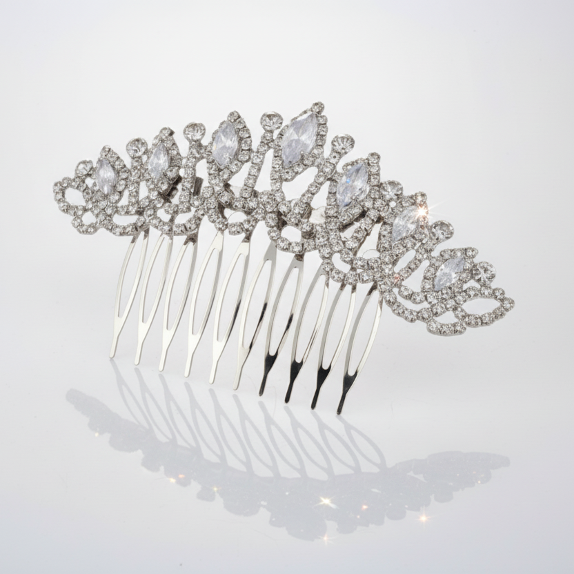 Silver hair comb with crystal embellishments on a light gray background
