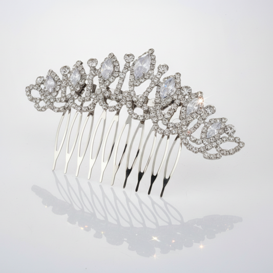 Silver hair comb with crystal embellishments on a light gray background