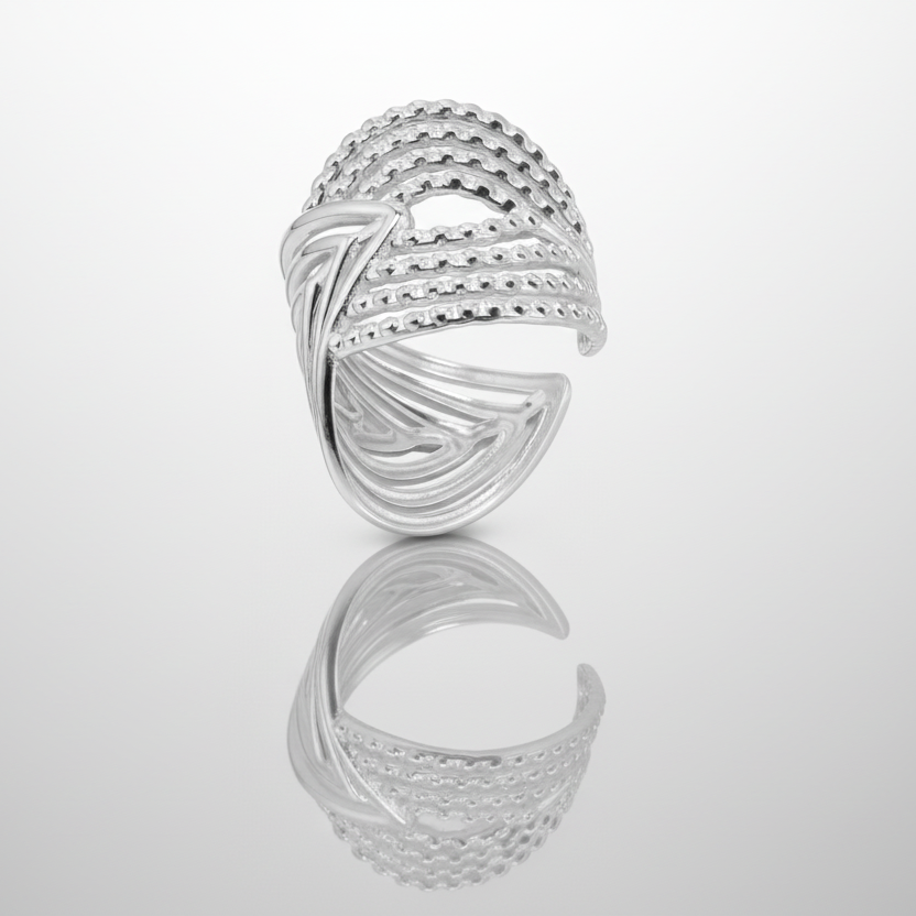 Silver ring with a braided design on a white background