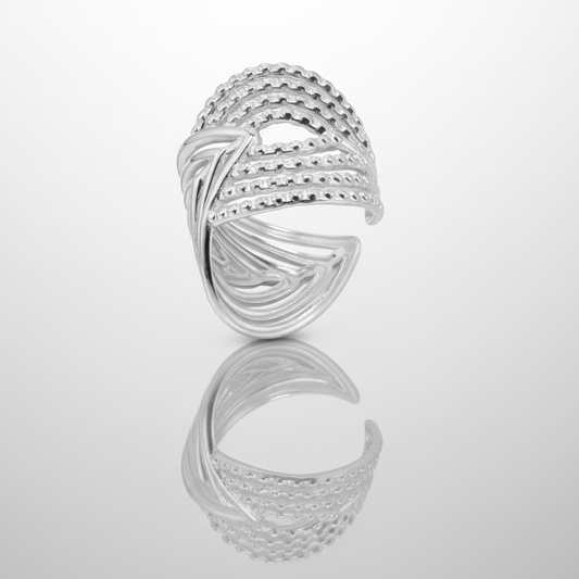 Silver ring with a braided design on a white background