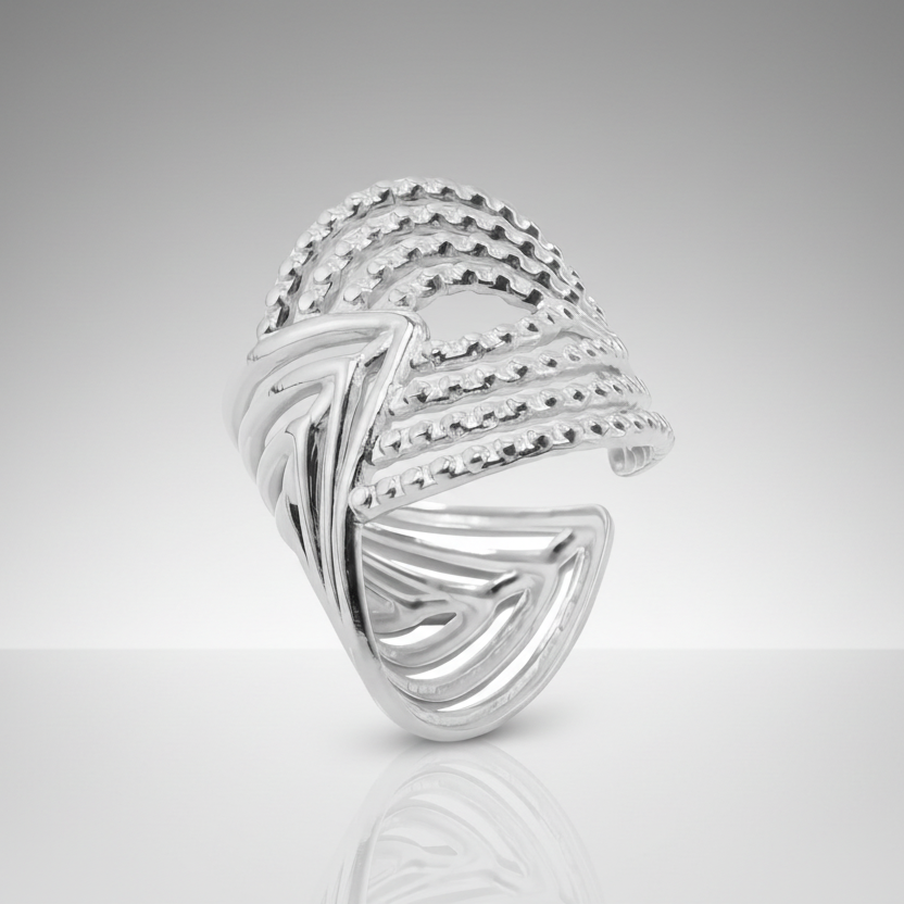 Silver ring with intricate design on a white background