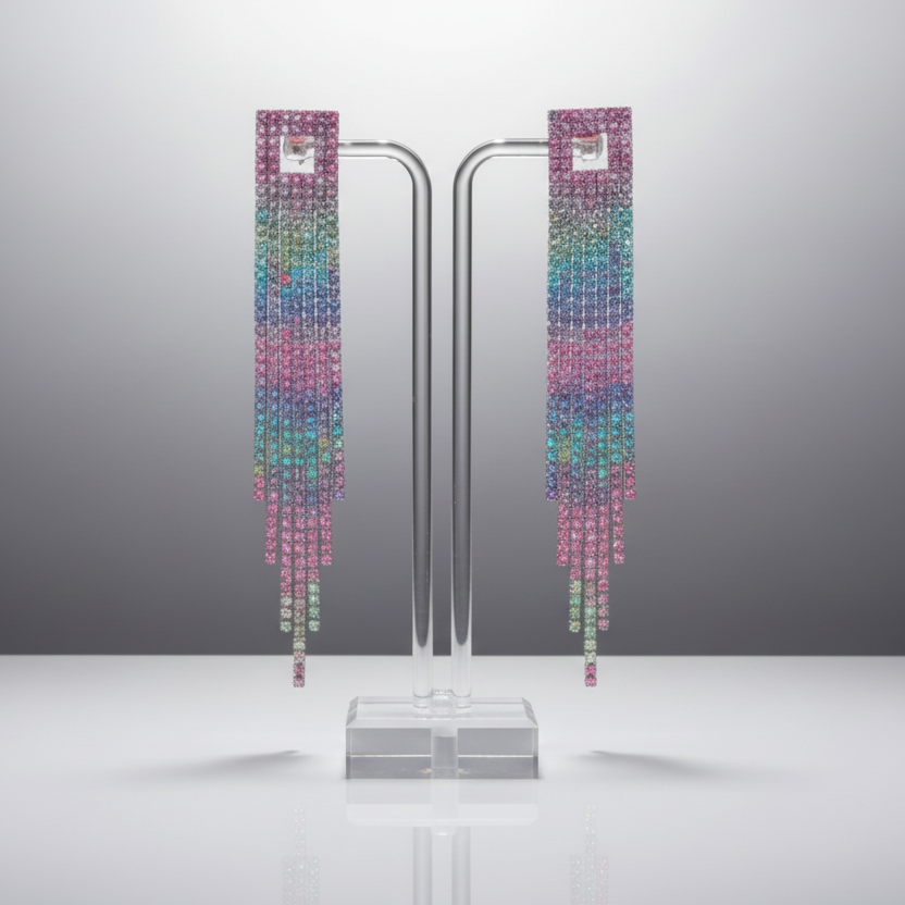 Colorful earrings on a stand against a gray background