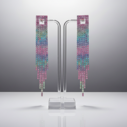 Colorful earrings on a stand against a gray background