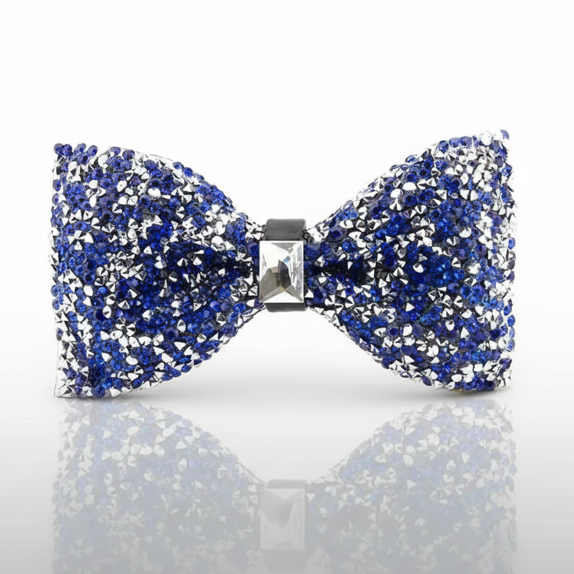 Blue and silver bow tie with rhinestones on a reflective surface