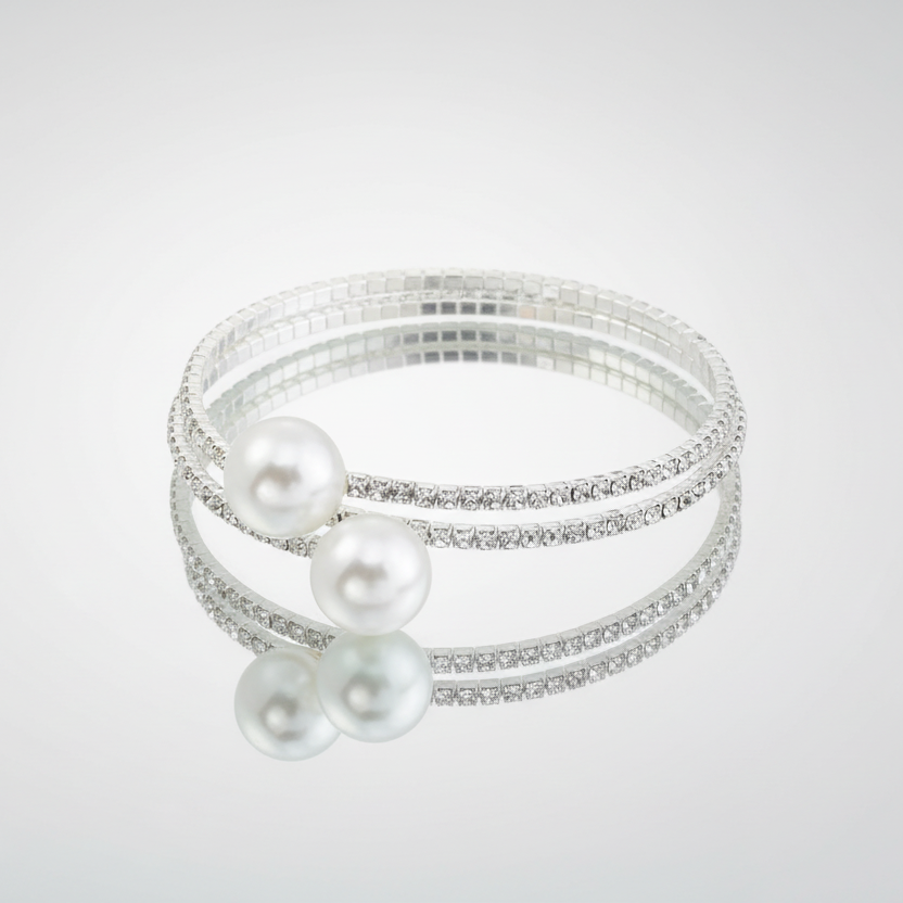Two pearl bracelets with silver bands on a light gray background