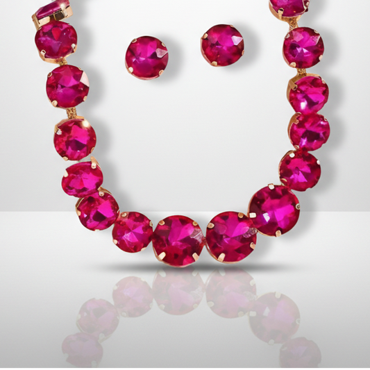 Necklace and earrings with bright pink gemstones on a light gray background