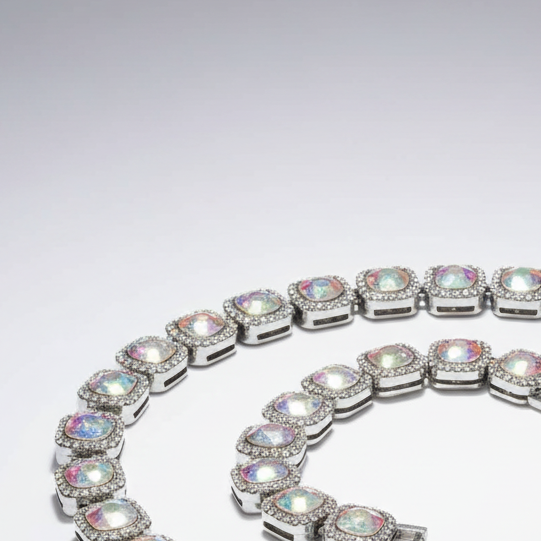 Silver bracelet with multicolored gemstones on a light gray background
